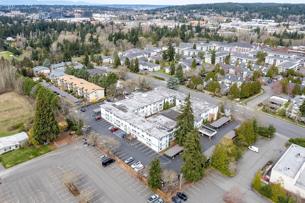 an aerial view of a building in a parking lot